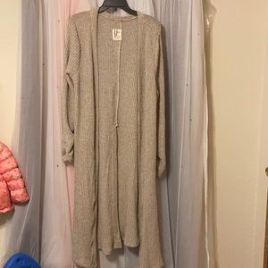 Cardigan tan, button up on back, slits on side